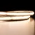 Close-up of two segments of a cool white COB LED strip, illuminated to show its seamless, dotless light output.
