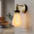 Plumen 6W LED Iconic Bulb in ultra warm white 2200K, part number 002PL, showcasing its distinctive and elegant shape. This energy-efficient and dimmable bulb offers modern style and functionality.