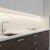 A 2 metre recessed mounted silver LED profile illuminates a modern kitchen countertop with a sleek design. The LED strip provides soft, diffused lighting above the sink and workspace.