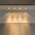 Four standard halogen GU10 Par16 downlights recessed into a white ceiling panel, casting warm white light downwards.