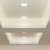 Recessed V-Tac 18W square LED panels illuminate a modern ceiling with a crisp daylight glow. The panels are flush-mounted in stepped ceiling recesses.